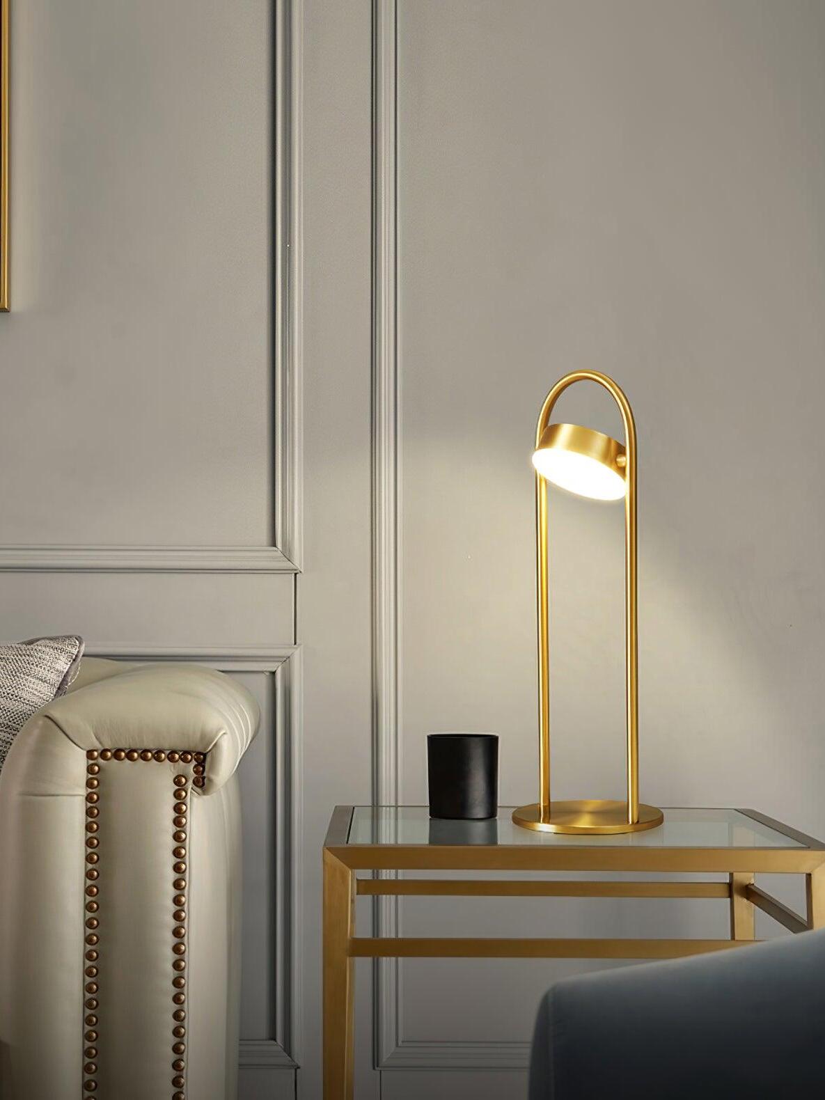 Upright brass arch lamp on glass side table