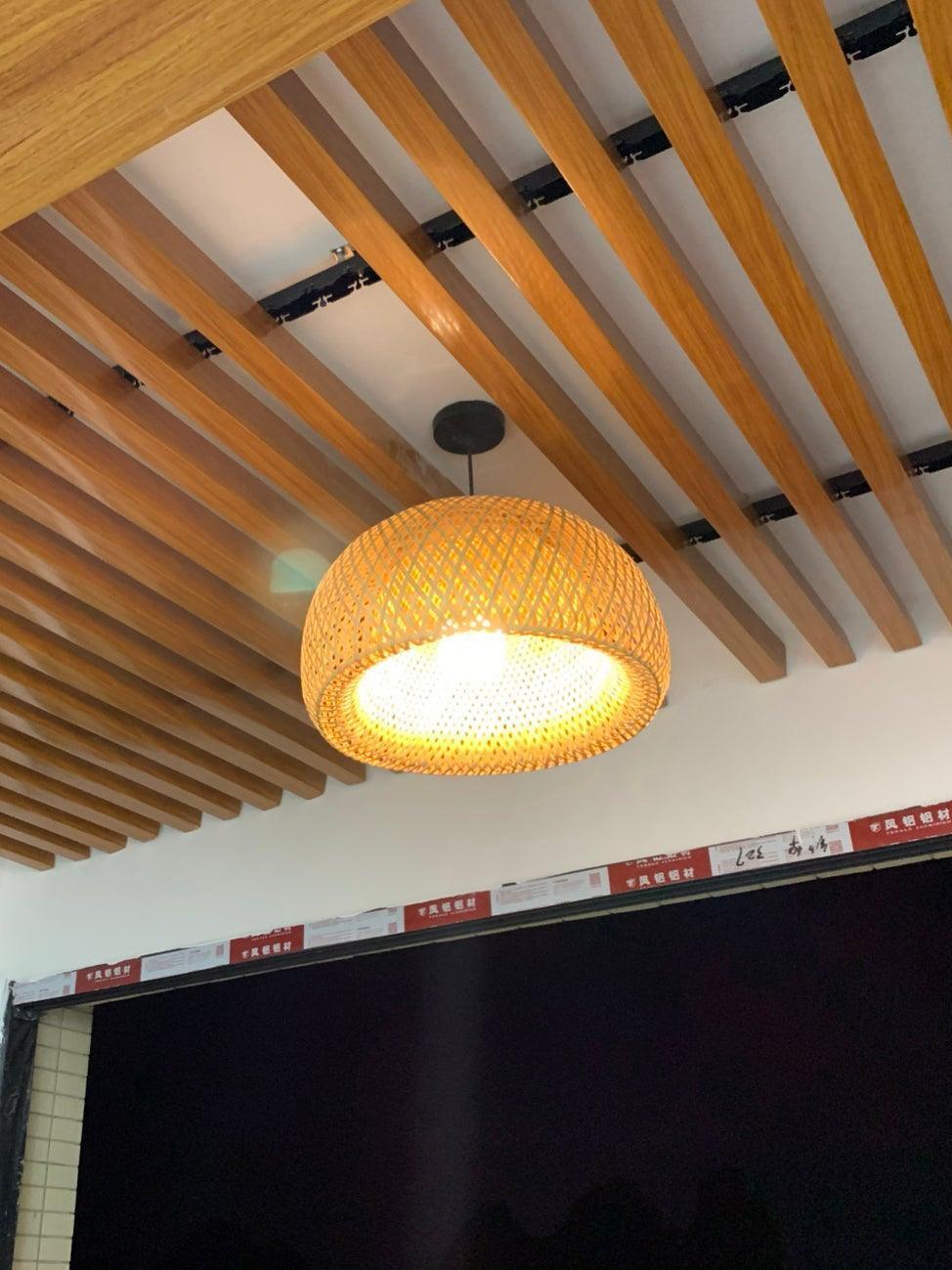 Large lattice dome pendant below timber ceiling slats