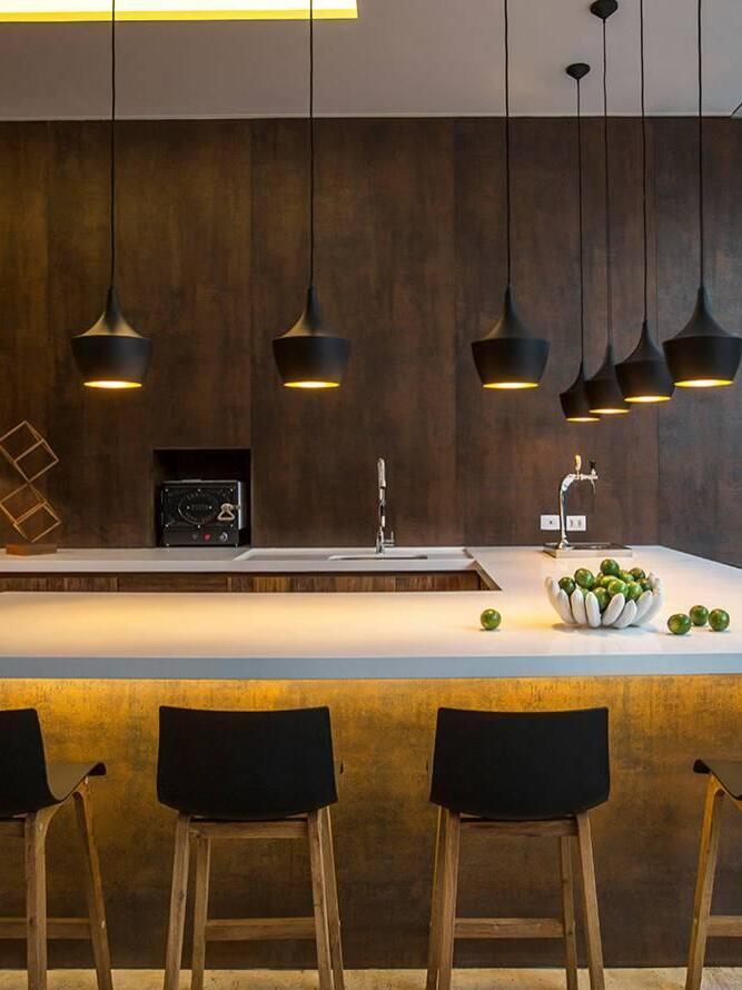 Black rounded pendants above a long bar