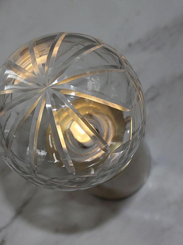 Top close-up of glass facets reflecting warm-looking light