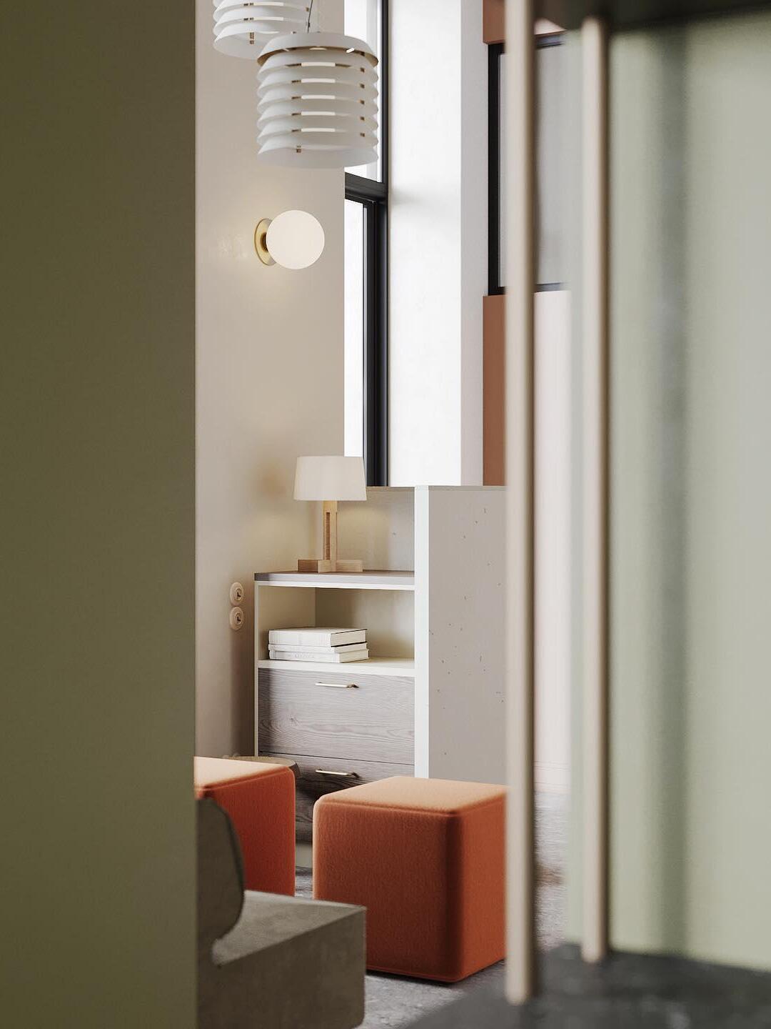 Layered pendants near tall window with round wall lights and orange seat