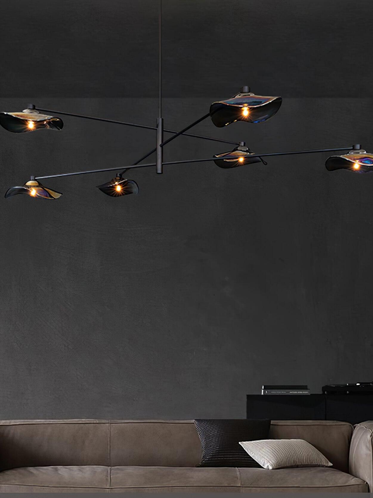 Black multi-arm glass chandelier over a sofa