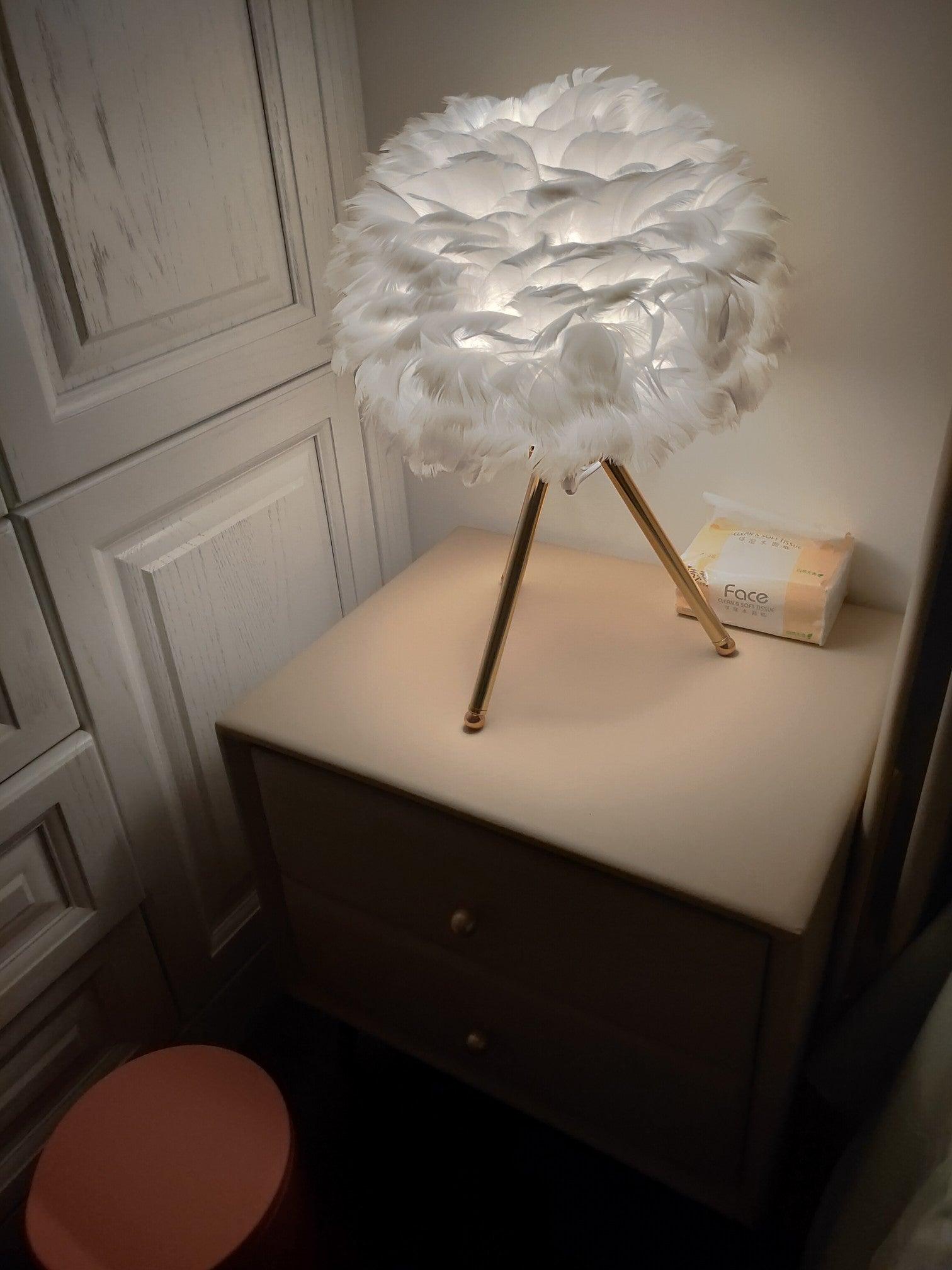 White feather lamp on dark-topped cabinet