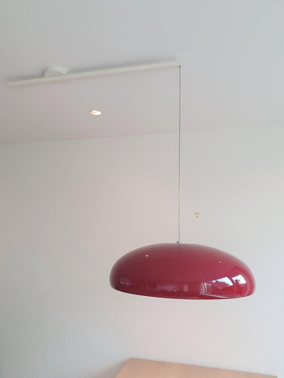 Red pendant on a long suspension cord