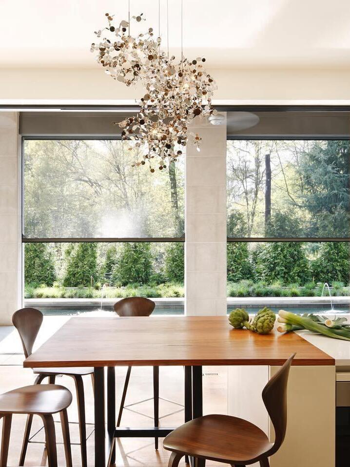 Warm disc clusters at varying heights over a wood dining table