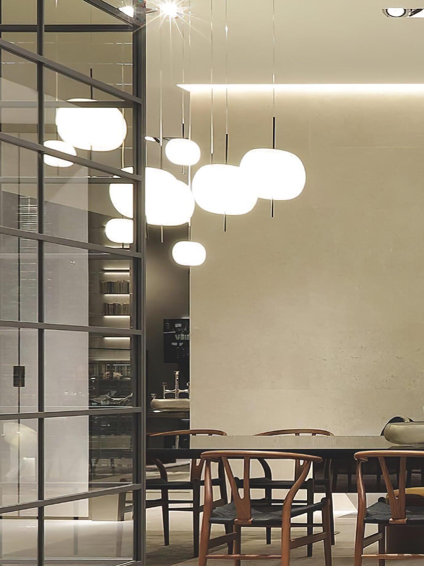 White pendant group in a dining space with a staircase