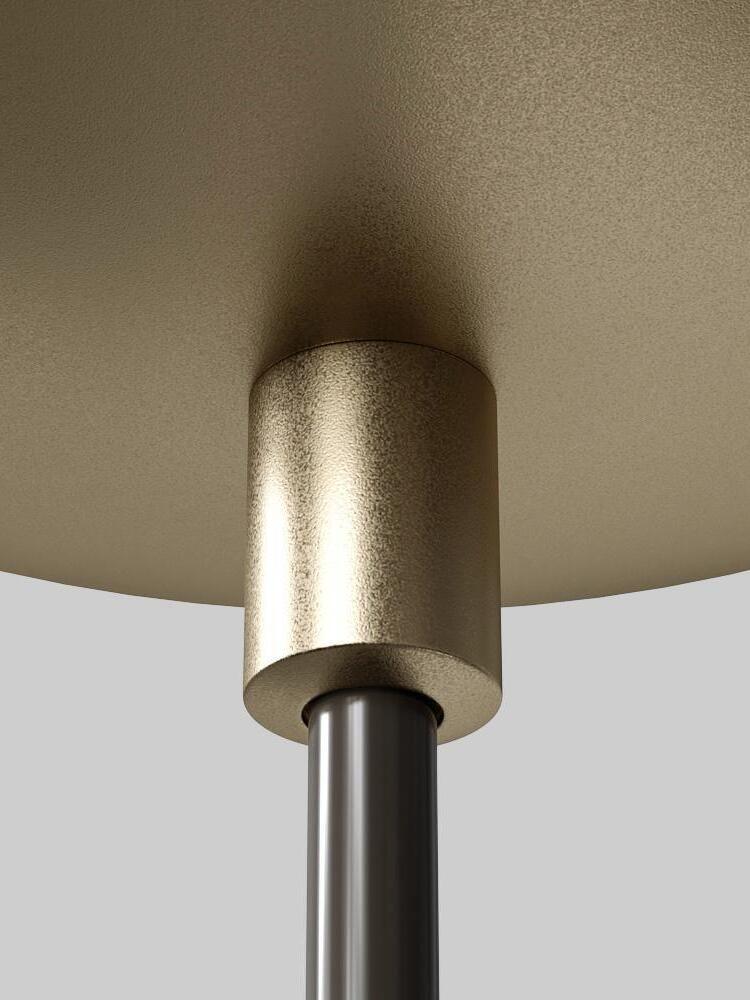 Close-up of gold-tone ceiling canopy and cylindrical entry fitting around a black suspension cable