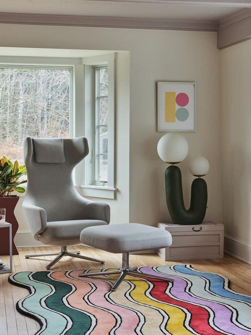 Green U-shaped lamp near an armchair