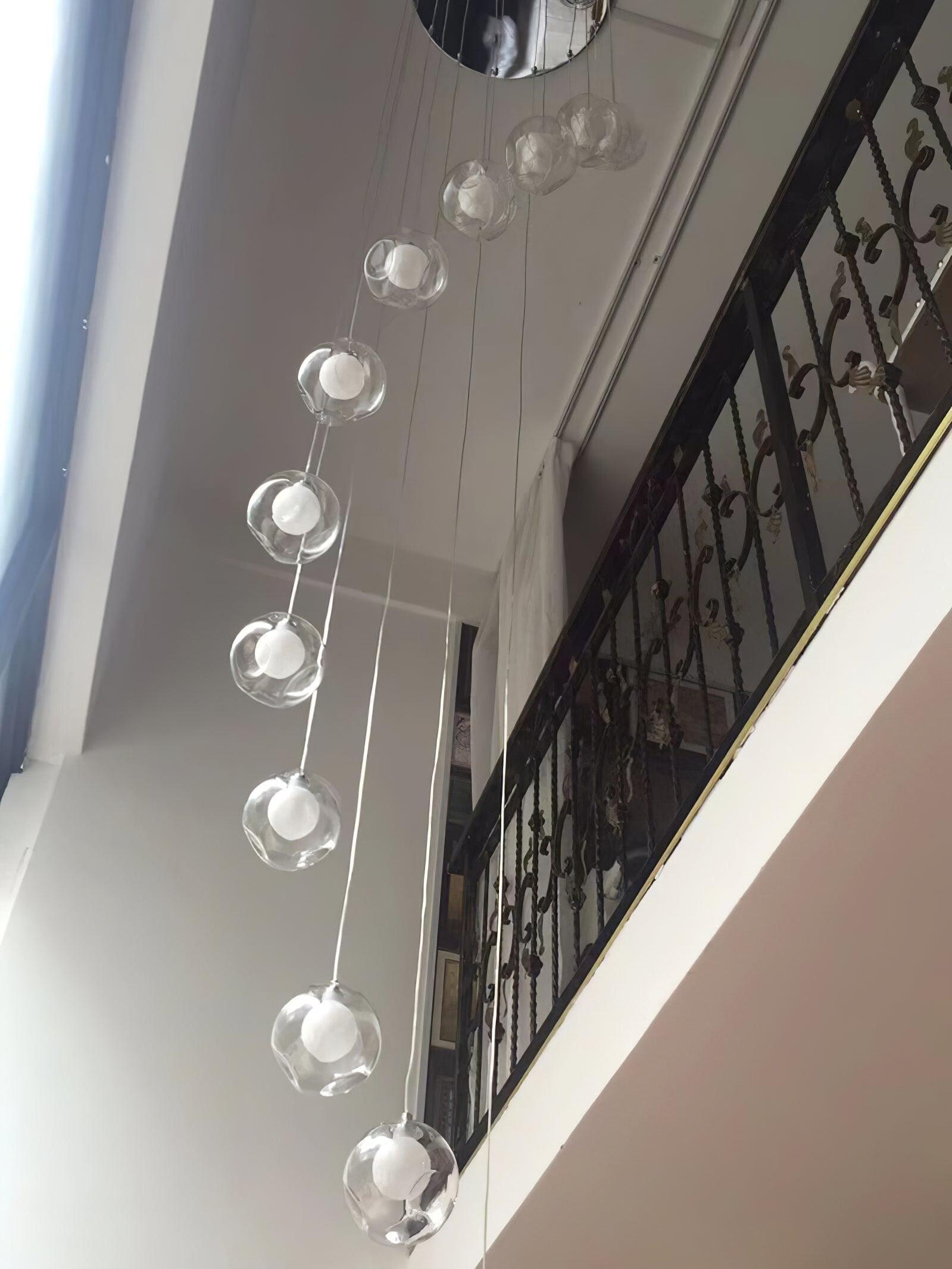 Clear globe pendants alongside stair landing
