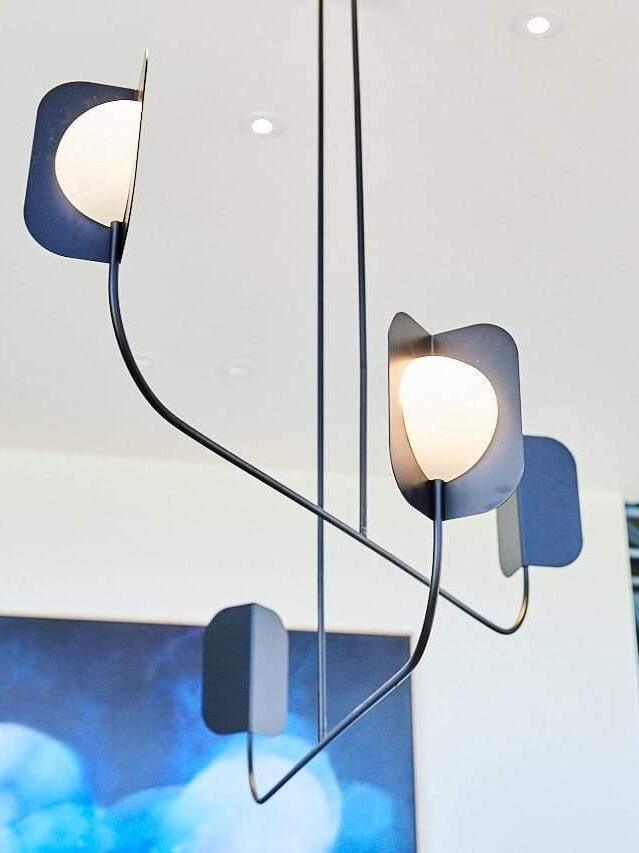 Close-up of black arm and white light element