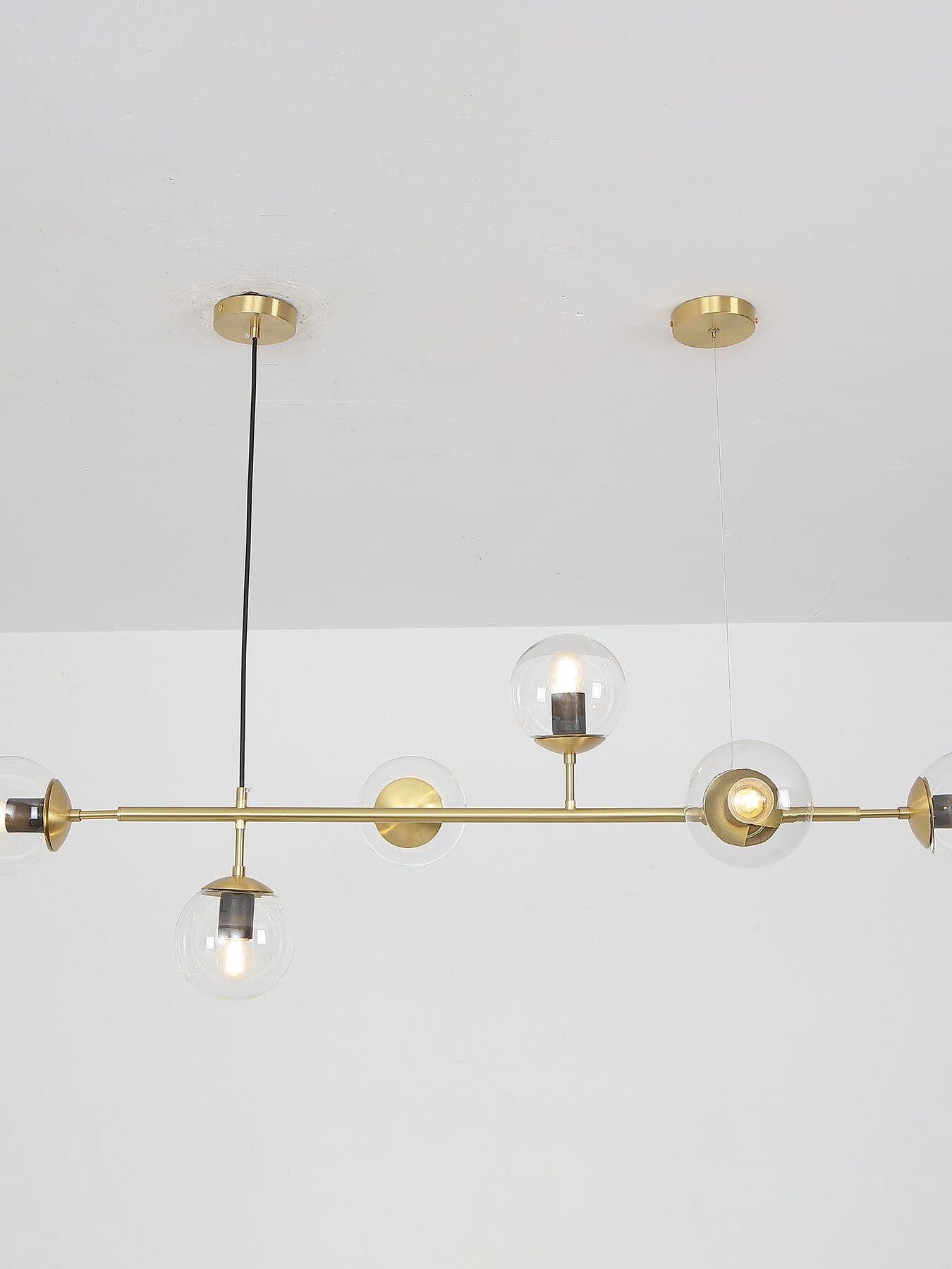 Clear globes along a brass-coloured horizontal frame