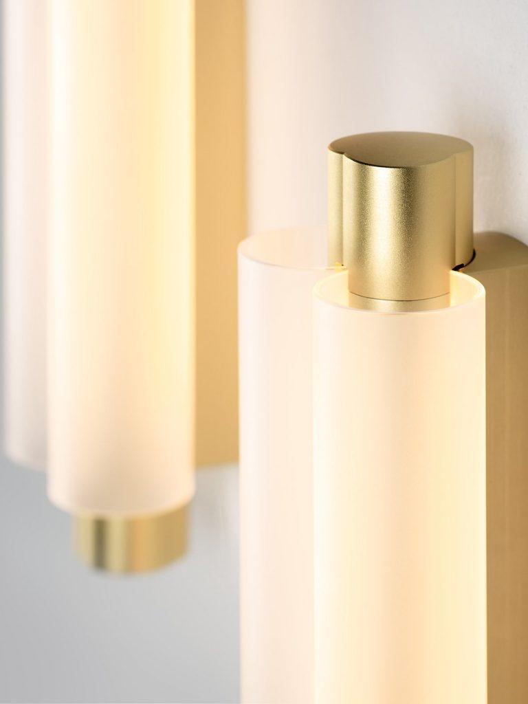 Close gold-tone upper detail beside curved translucent shade edge