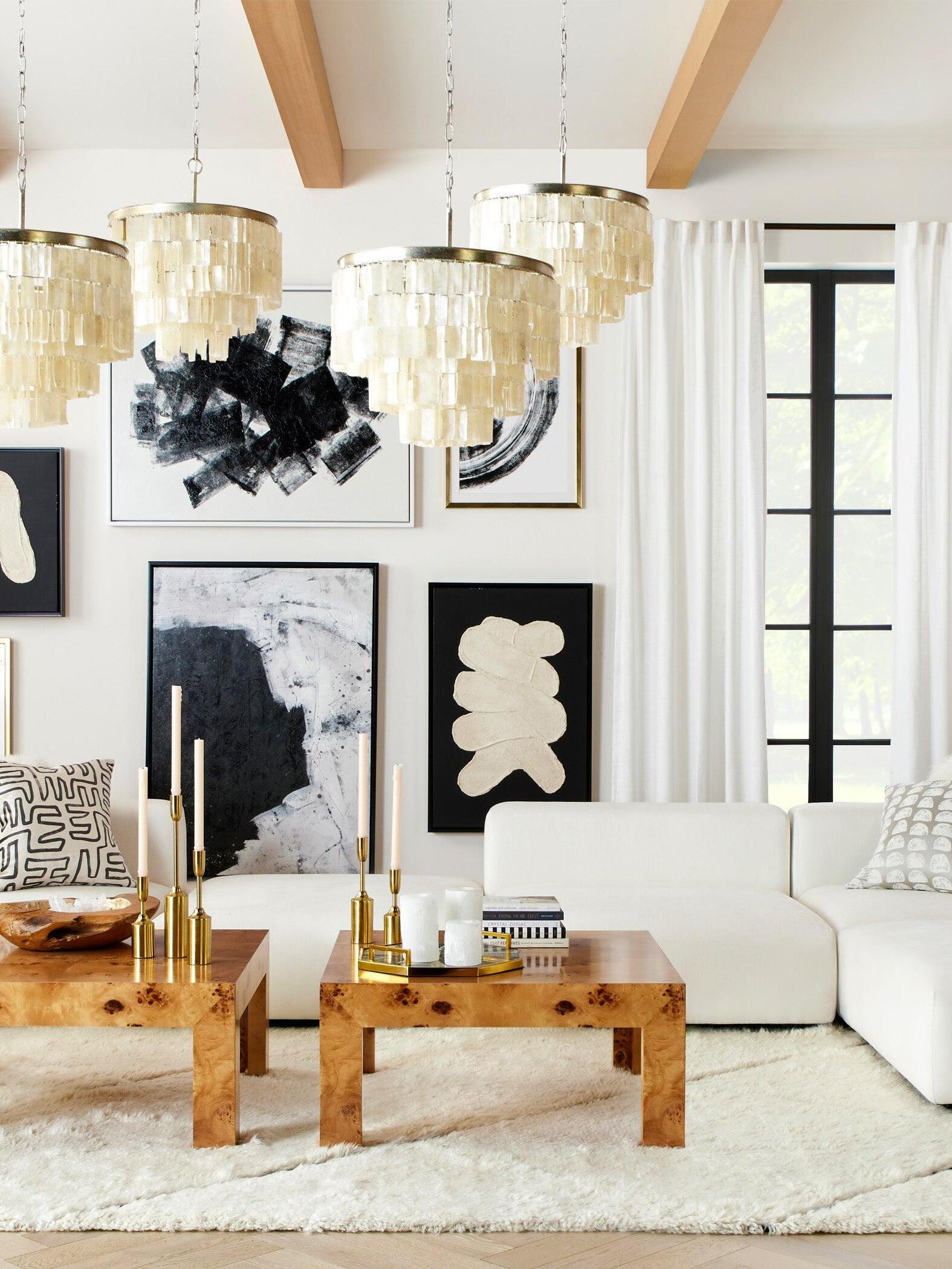 Decorative hanging lights beside tall living-room windows