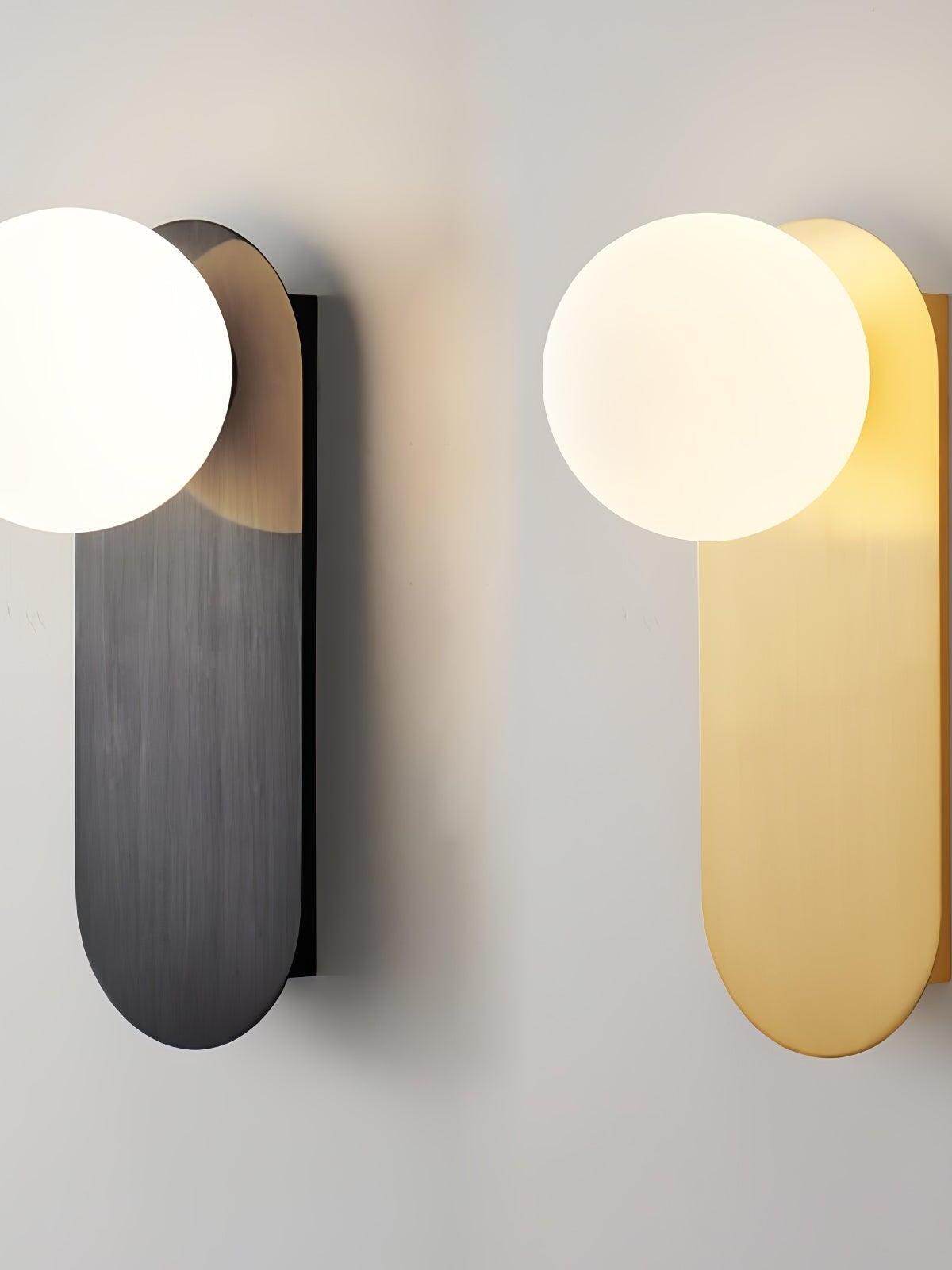 Black and Brass globe sconces displayed side by side