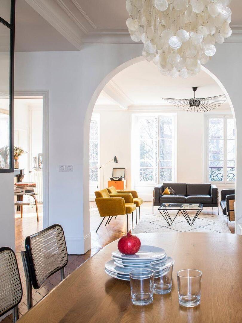Hanging shell discs in a bright room with an arch