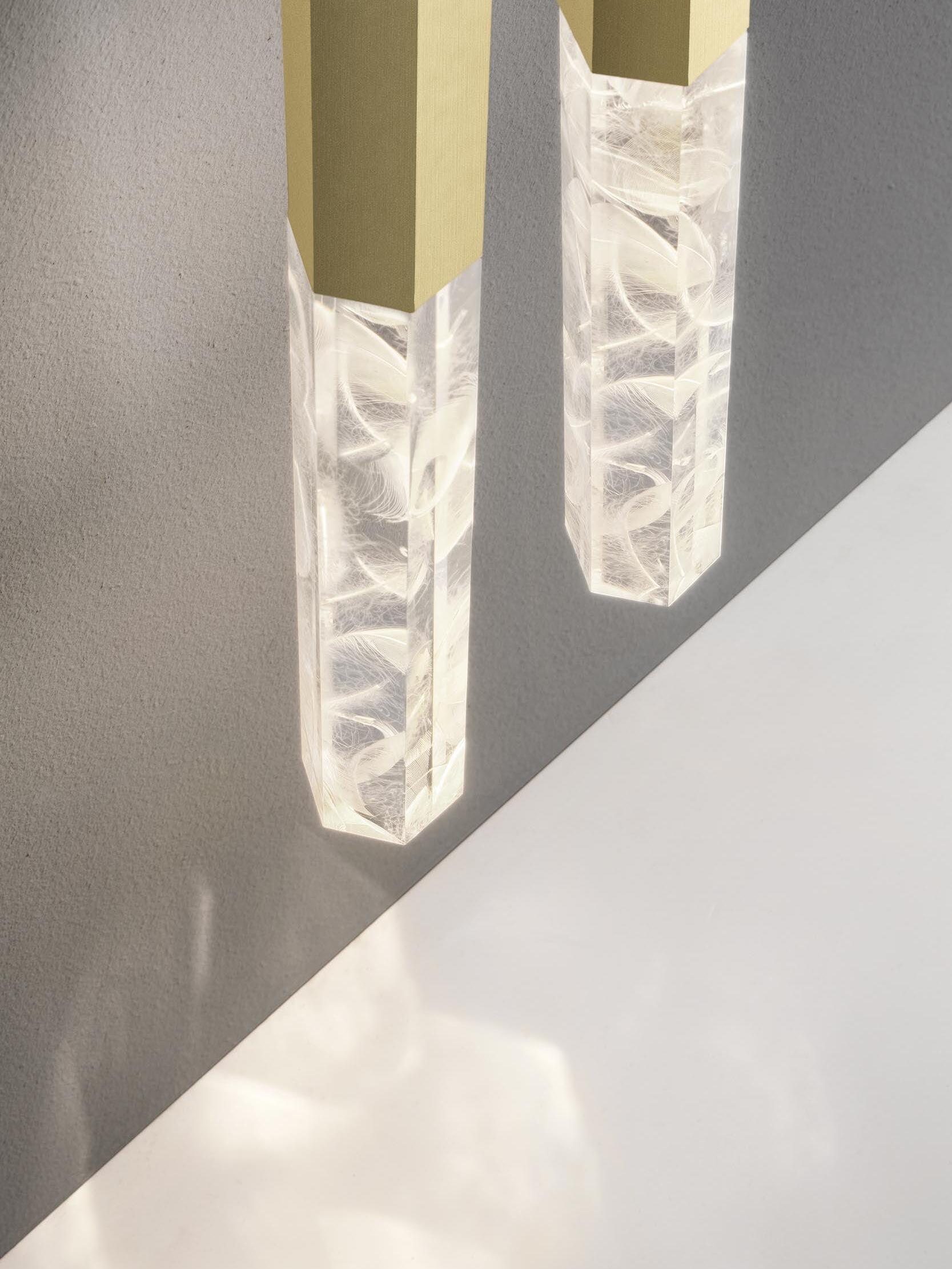 Clear rectangular crystal ends below flat gold-tone faces