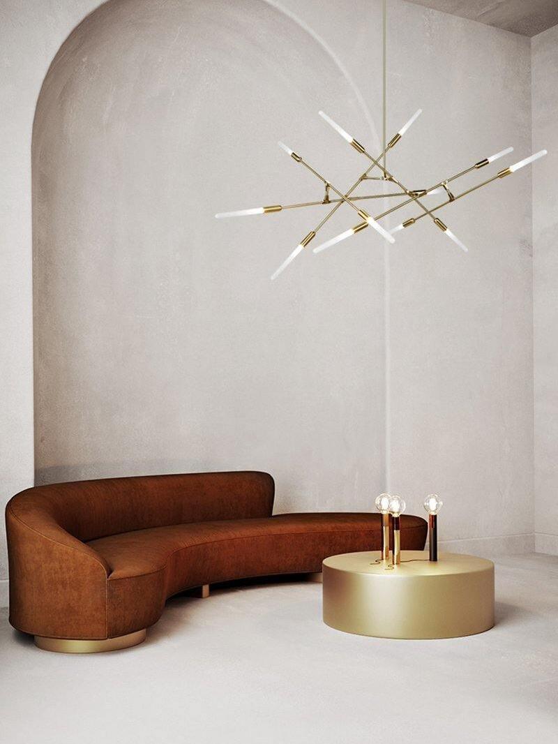 Gold branch fixture in an arched living space