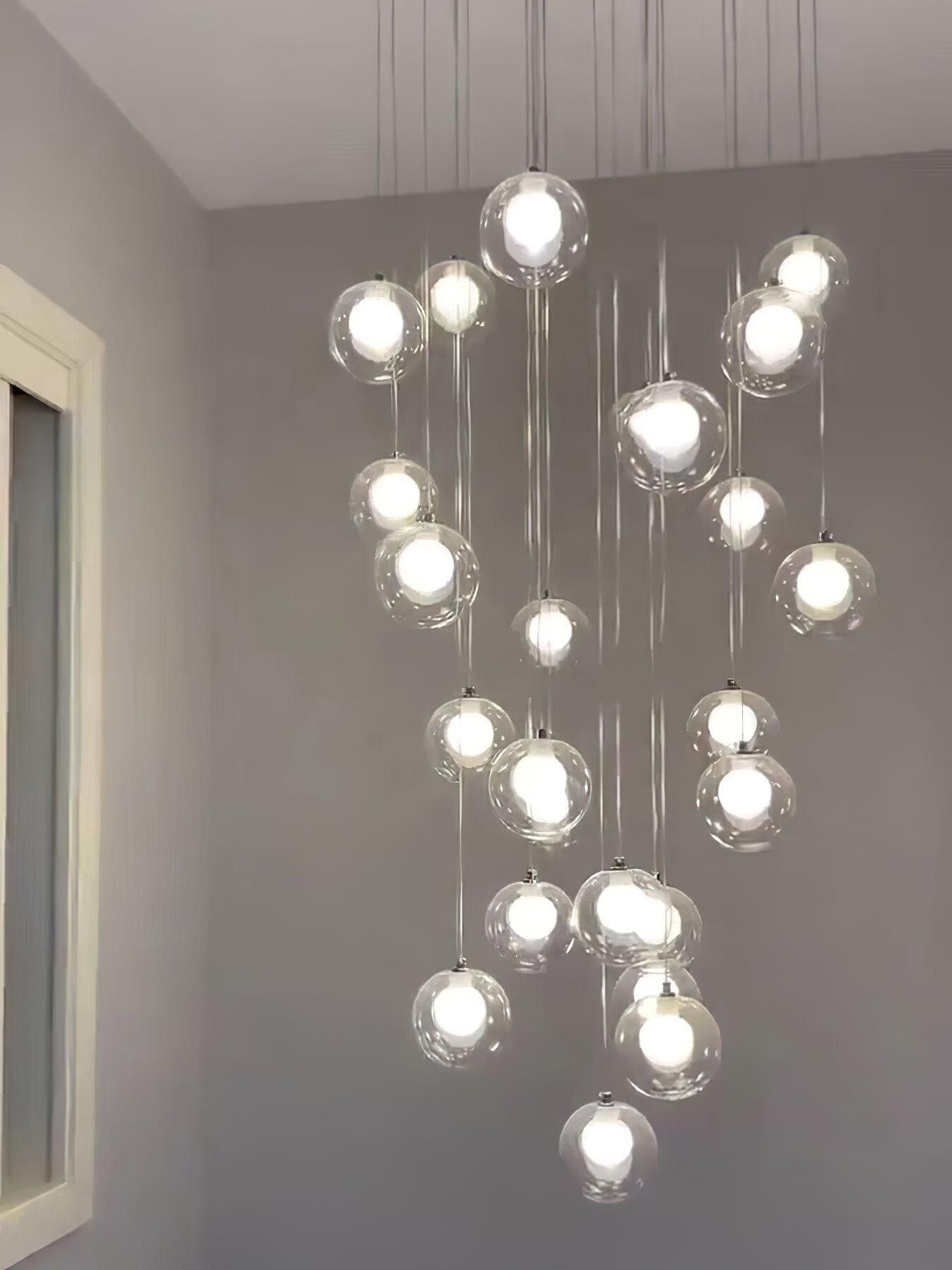 Many clear globes lit against pale wall