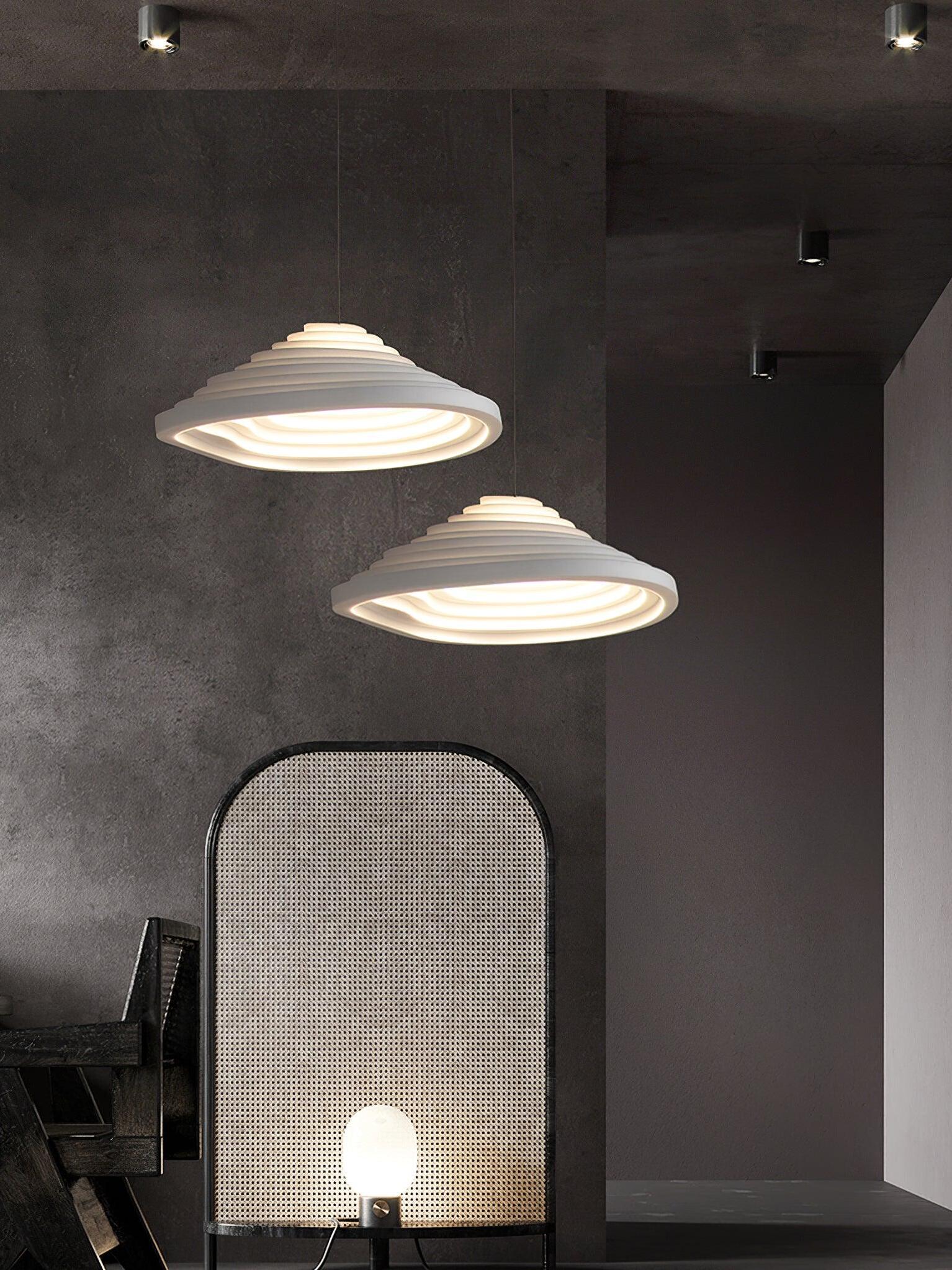 Two stepped pendants at different positions beside a tall mirror in a dark interior.