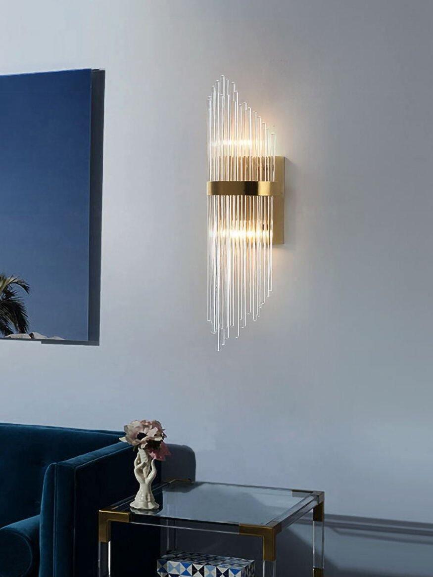 Crystal rod sconce above blue sofa beside framed picture