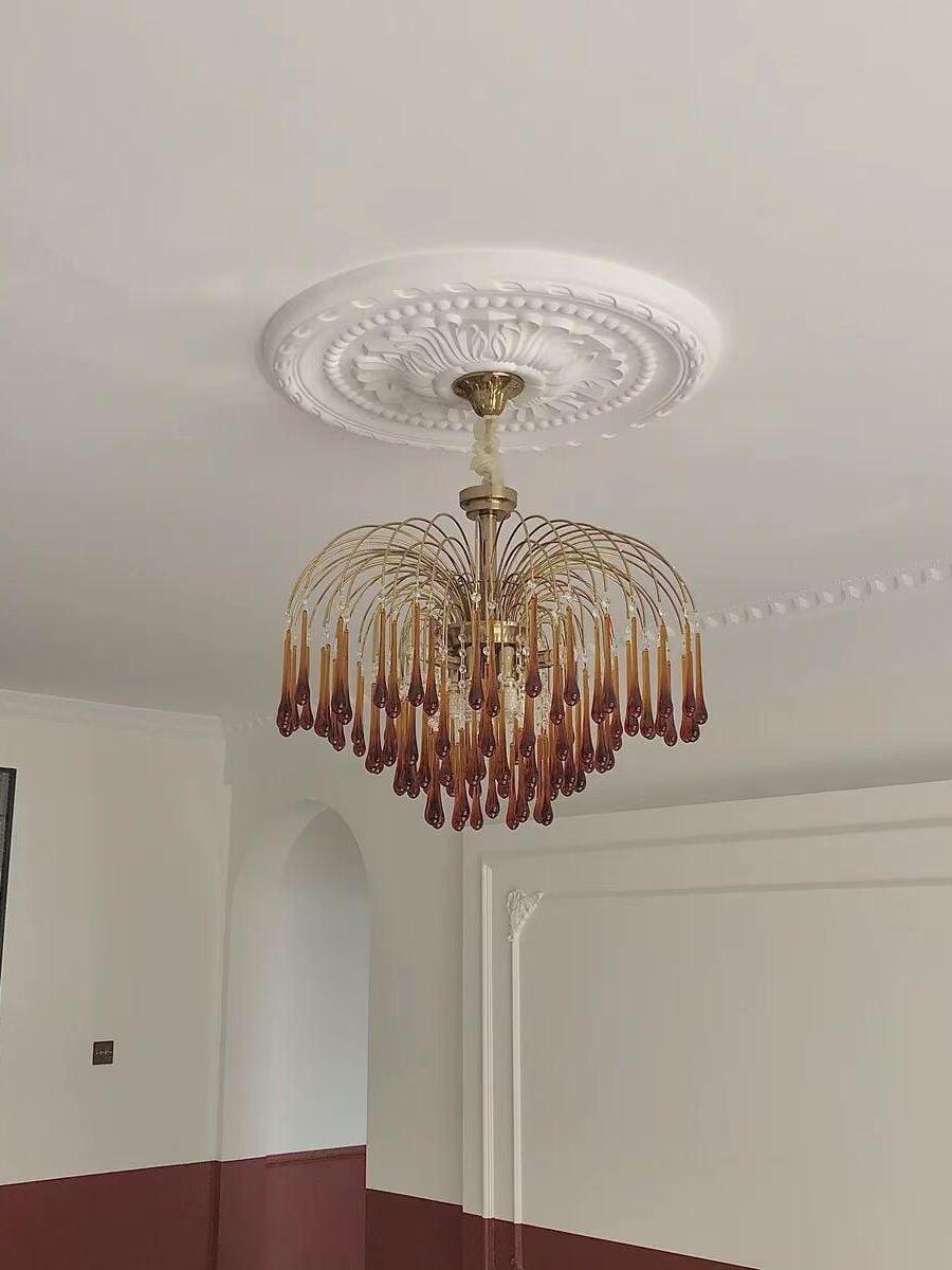 Wide amber-drop chandelier on a ceiling chain