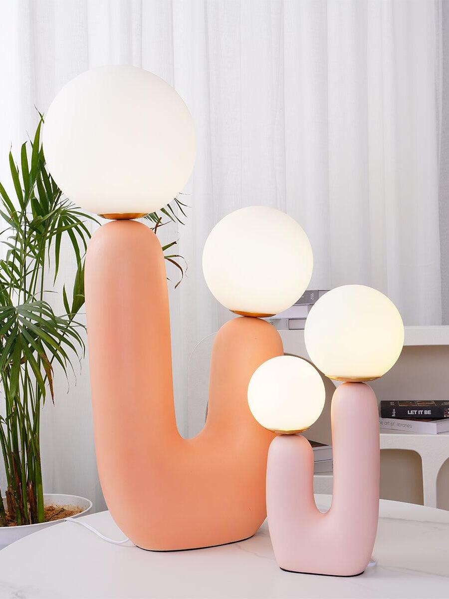 Pink-toned U-shaped lamps in different sizes