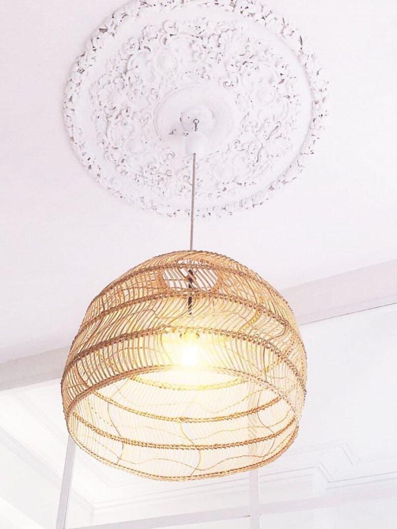 Underside of a glowing natural rattan shade