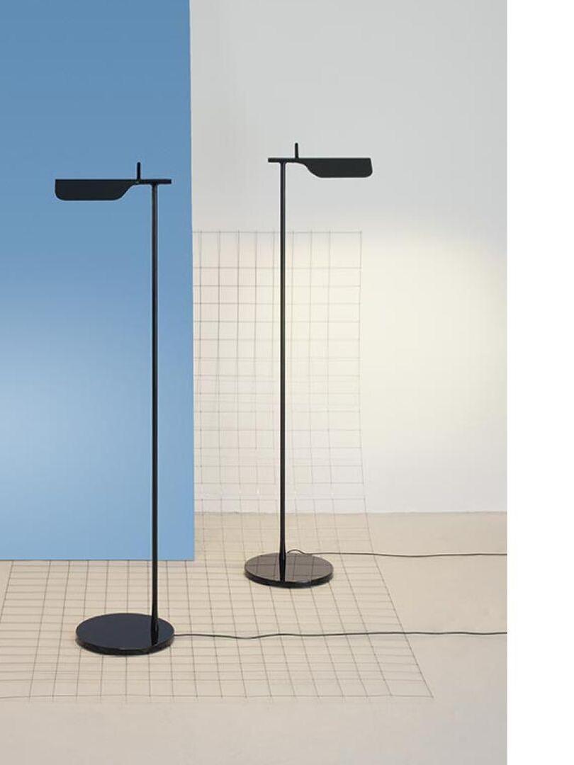 Blue and black floor lamps against a divided wall