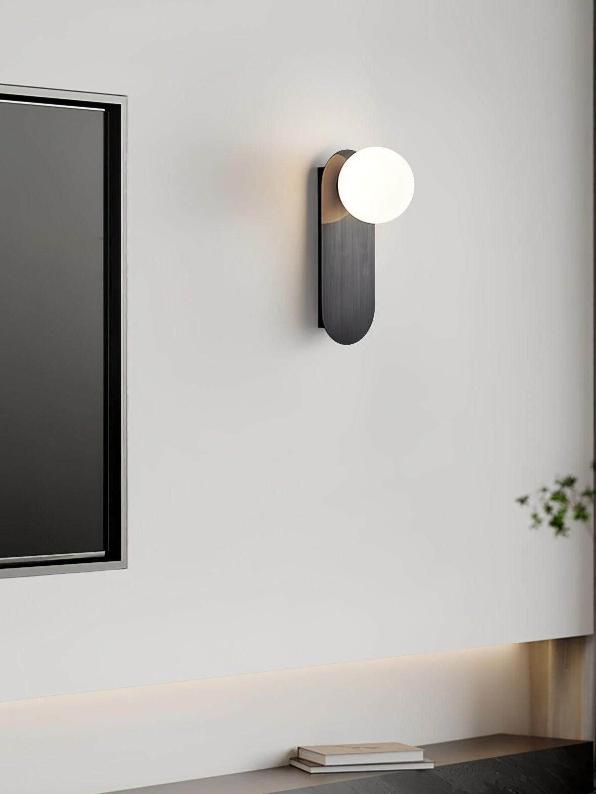 Black globe wall light near a television