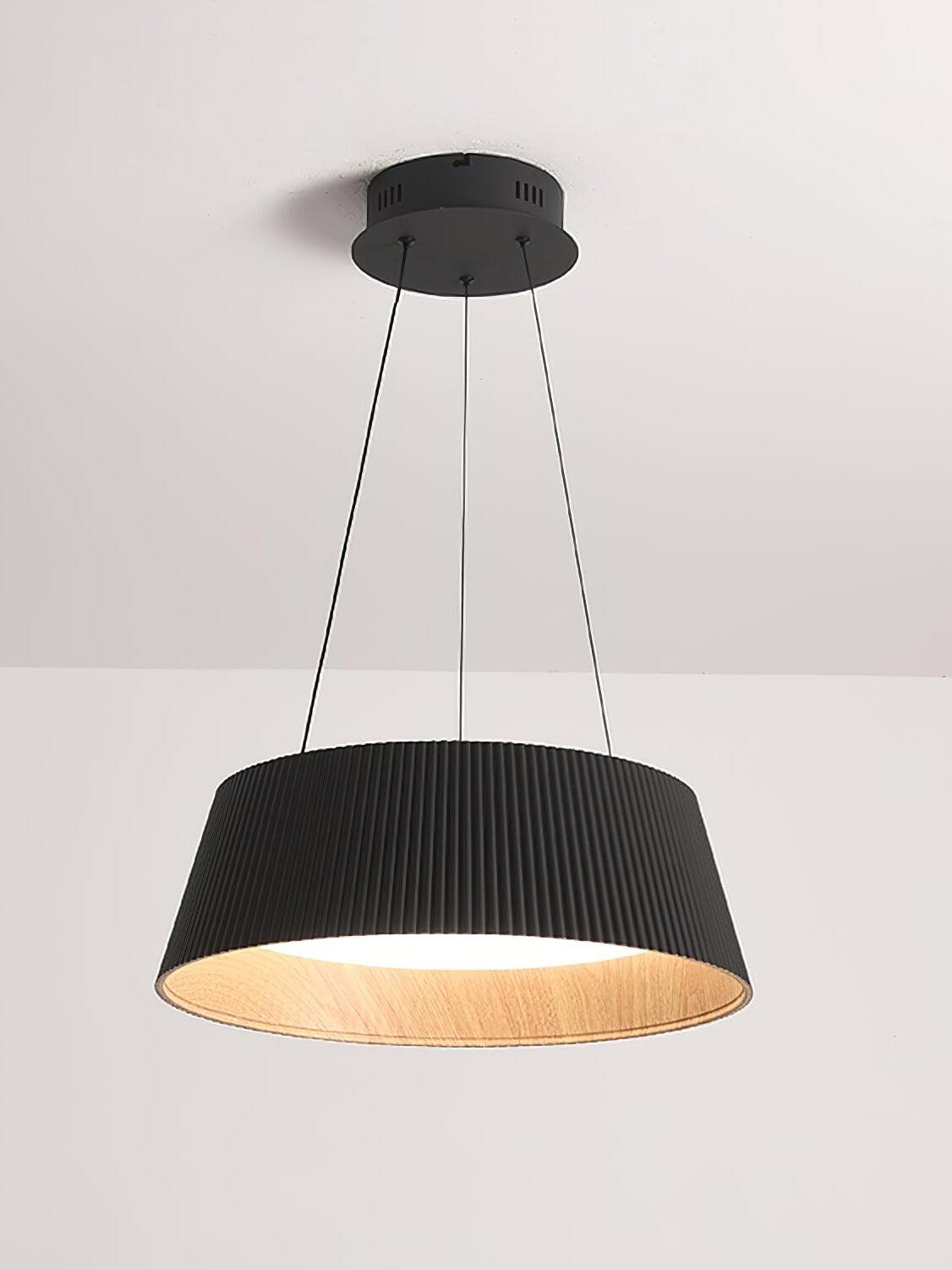 Modern Ribbed Black option with round canopy, three suspension lines, vertically ribbed shade and lit white diffuser