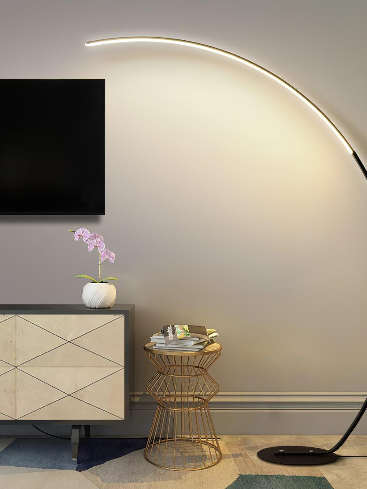 Black curved lamp beside television cabinet