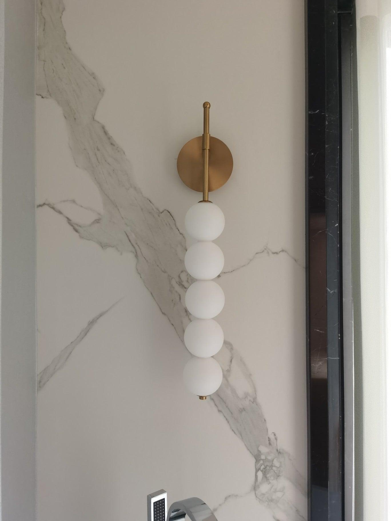 White globe lamp against a veined wall