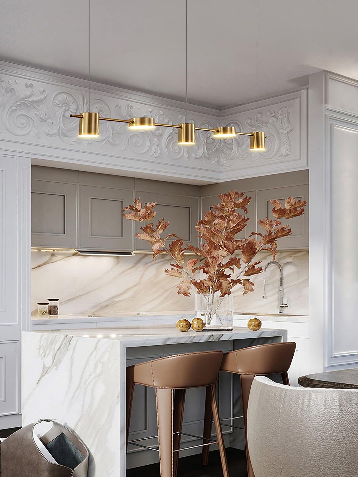 Gold linear pendant above a marble-patterned island