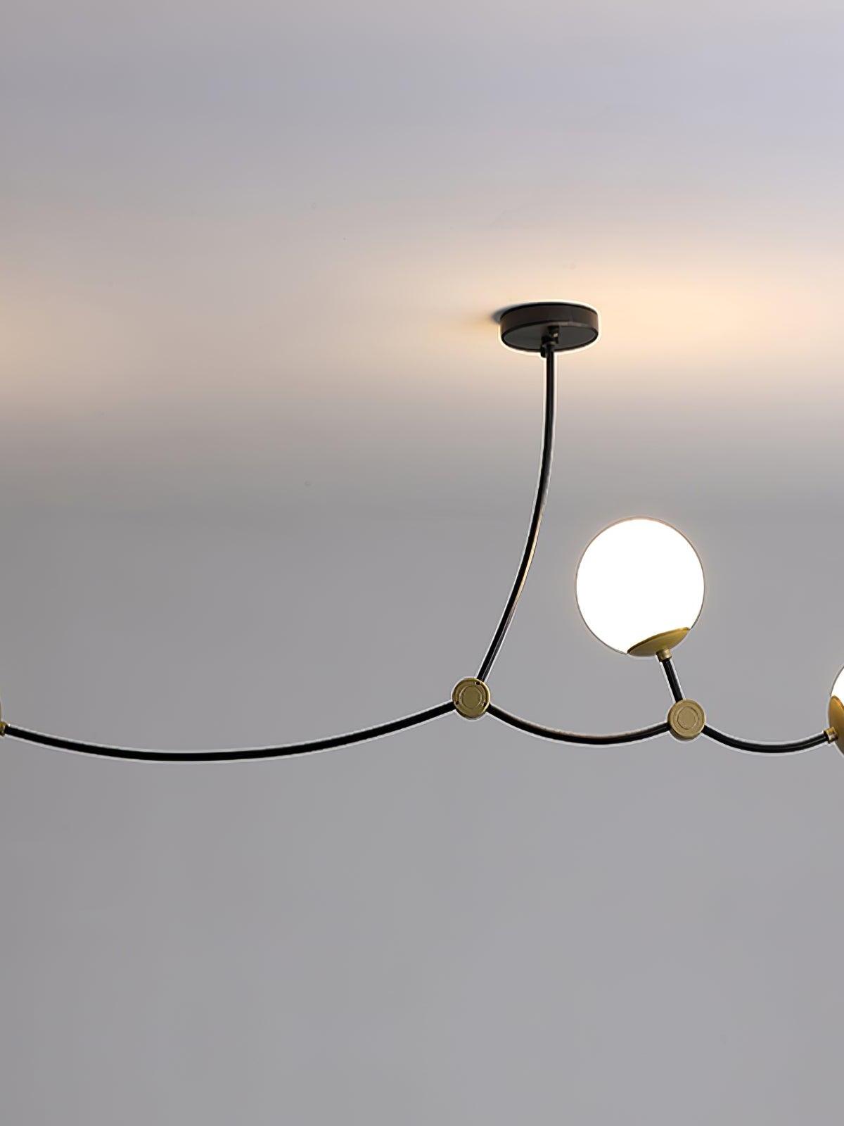 White glass globes on curved black chandelier arms beneath a round ceiling canopy