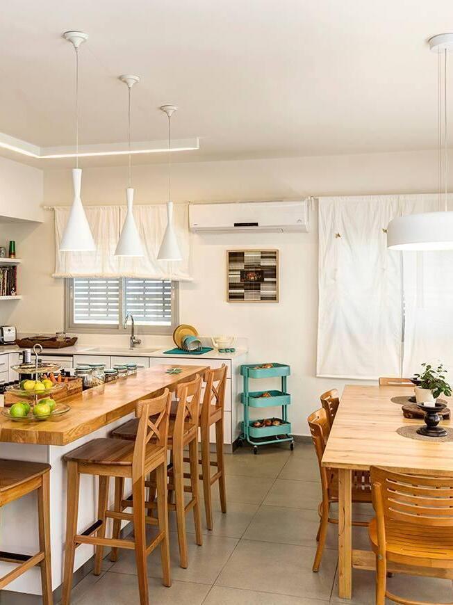 White cone pendants beside kitchen shelves