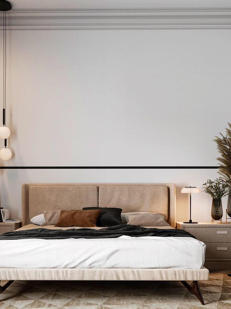 White single-globe pendant beside a bed