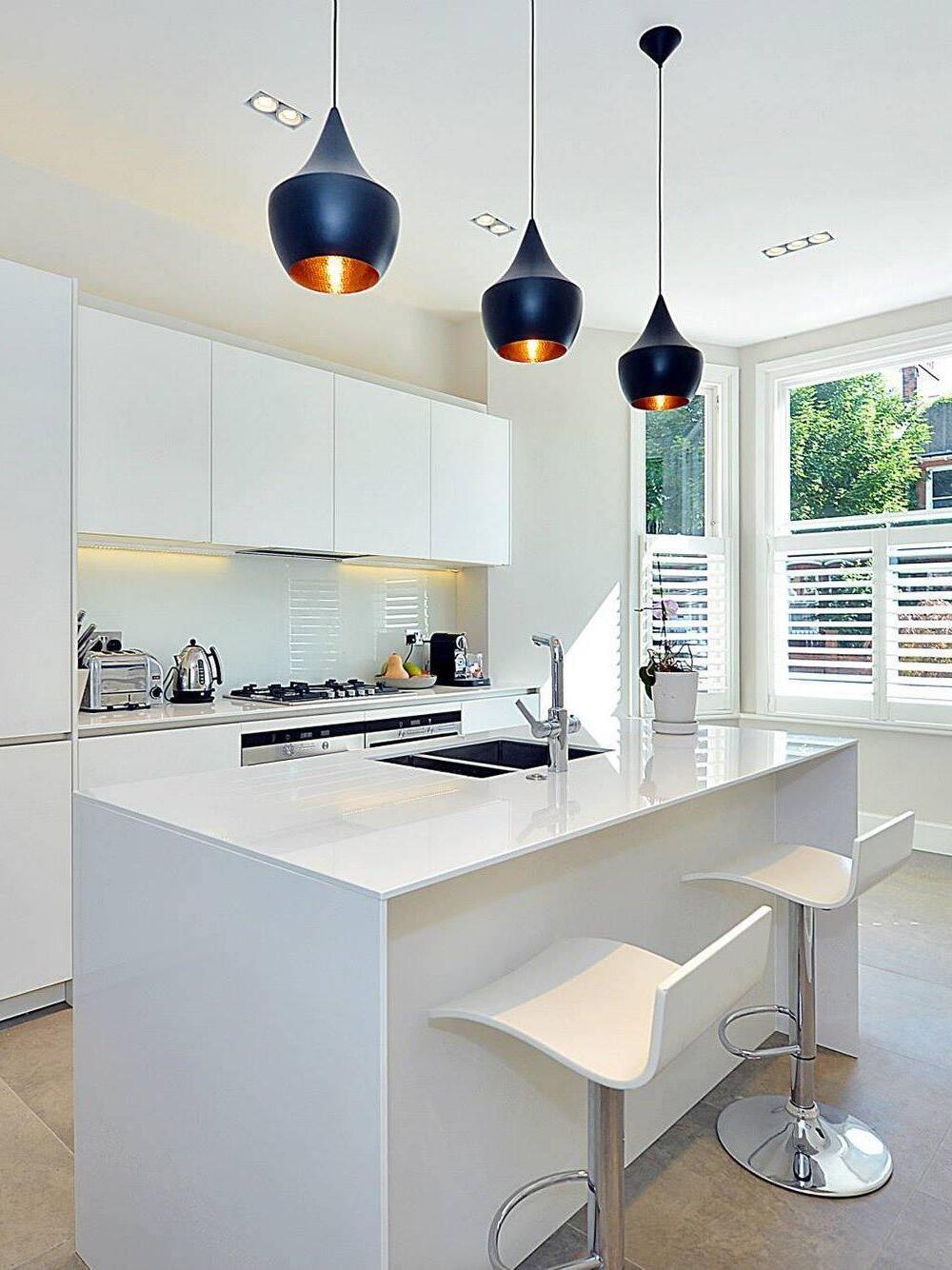 Black rounded pendants over a white island