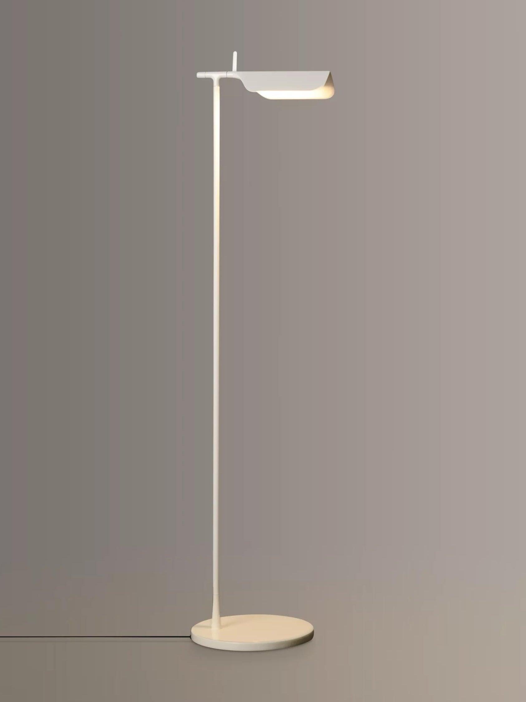 Full view of a white floor lamp with a folded hood