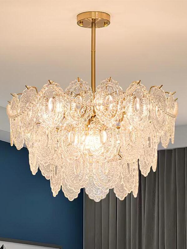 Glowing tiered chandelier against dark blue wall