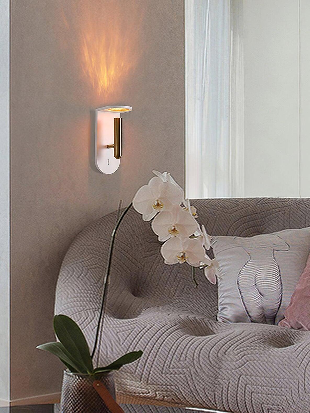 Illuminated white Nights wall light above a pale armchair with an orchid beside it