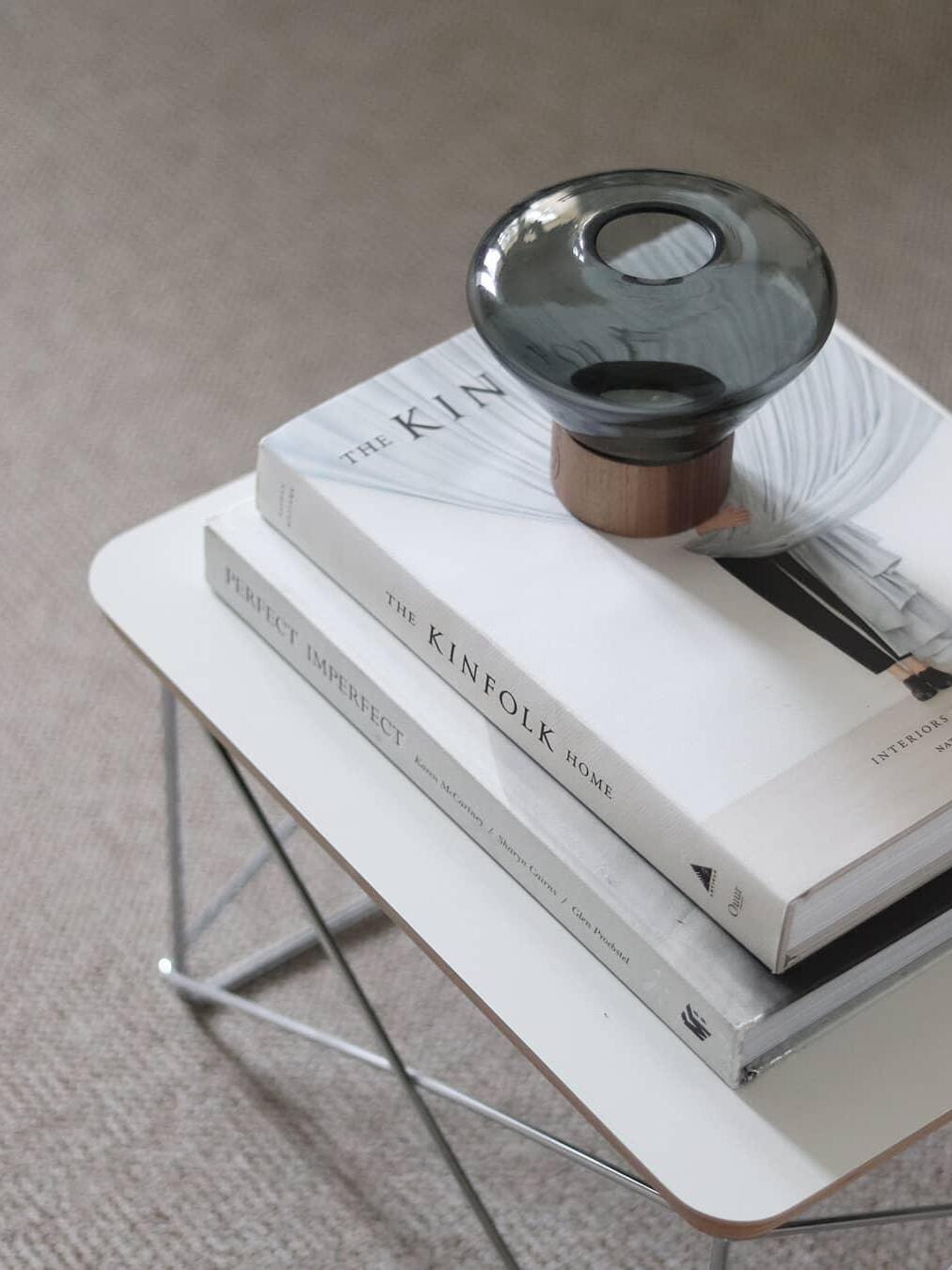 Closer unlit smoky rounded shade with top opening on book stack