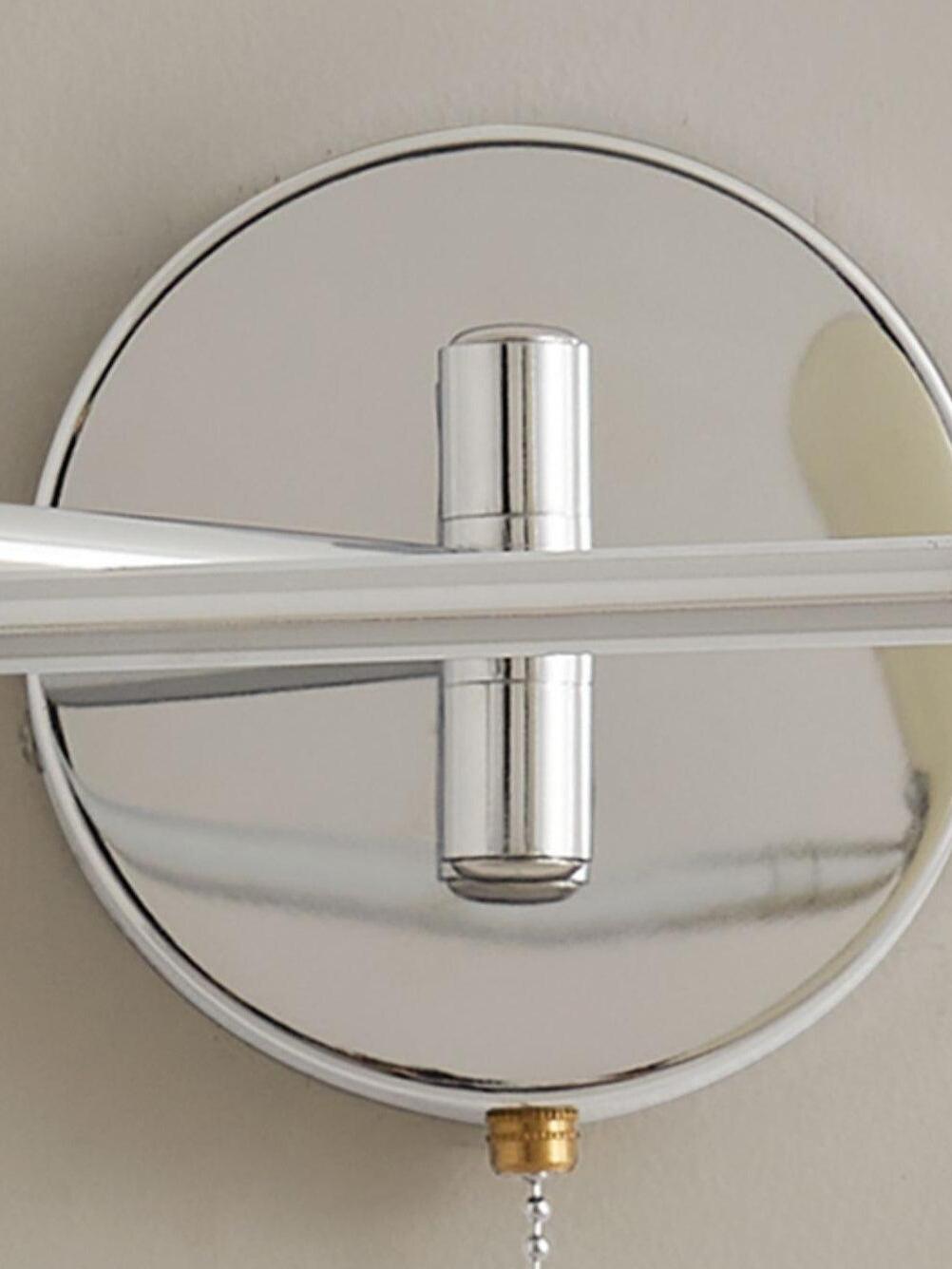 Close view of chrome wall plate, straight arm and hanging pull