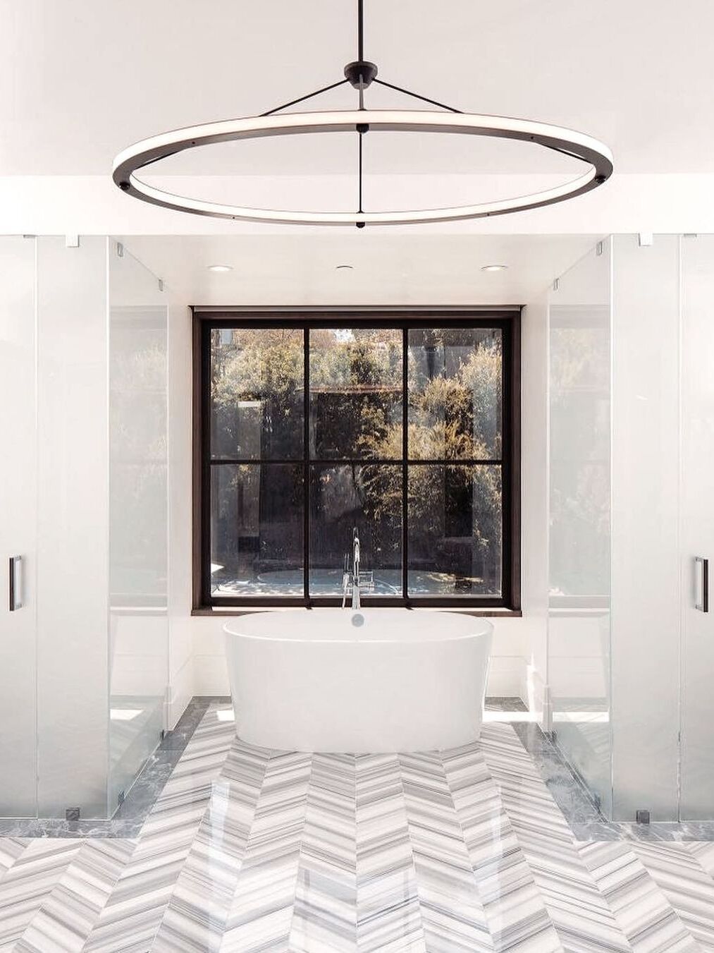 Single ring pendant pictured above a bathtub