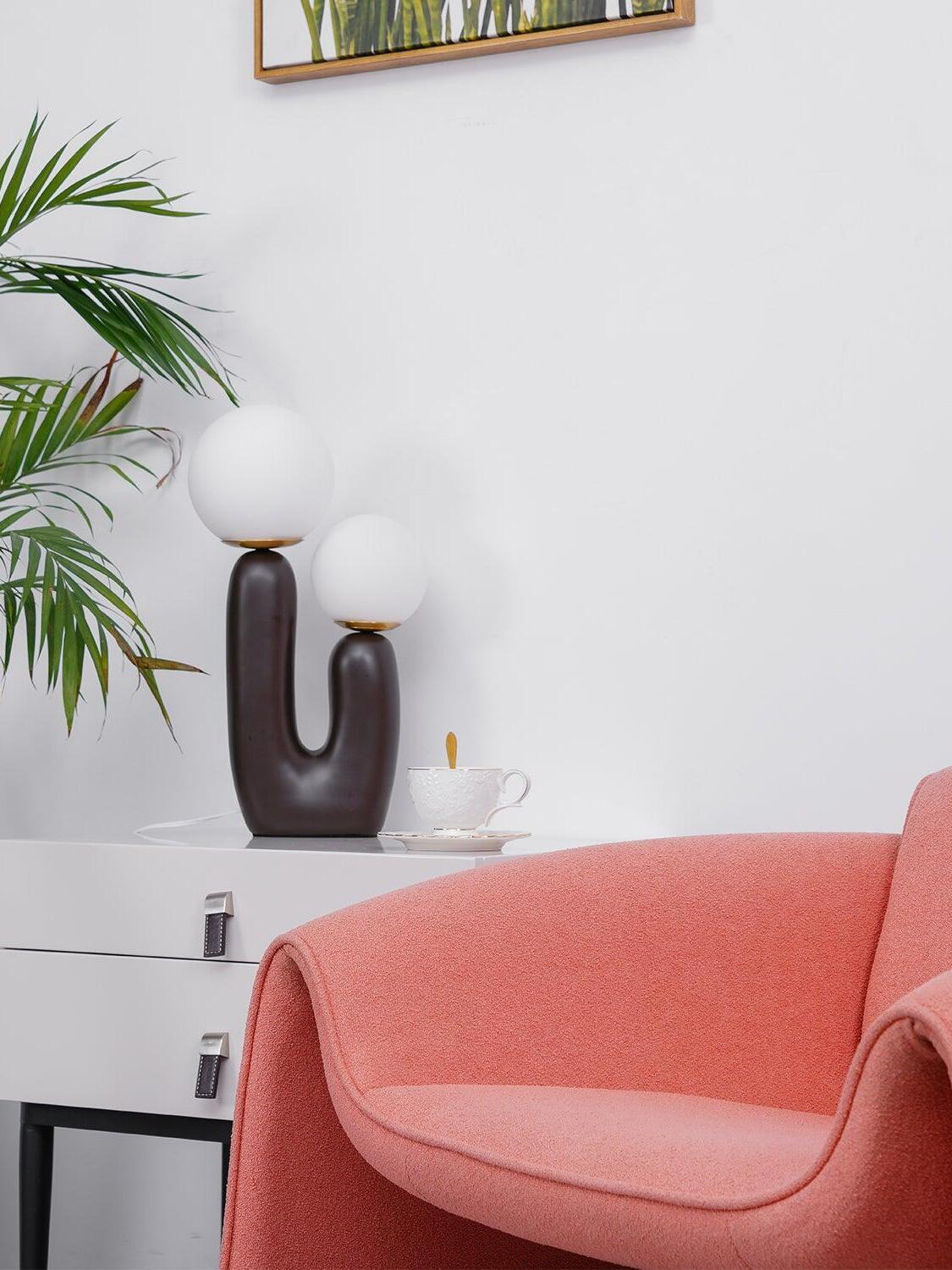 Dark Brown U-shaped lamp on a white cabinet