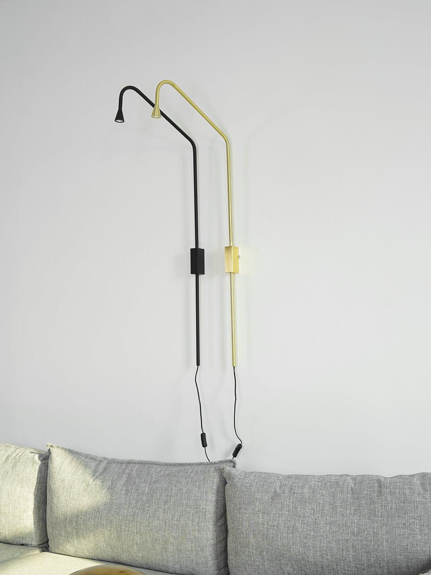 Black and Golden Austere fixtures above a sofa