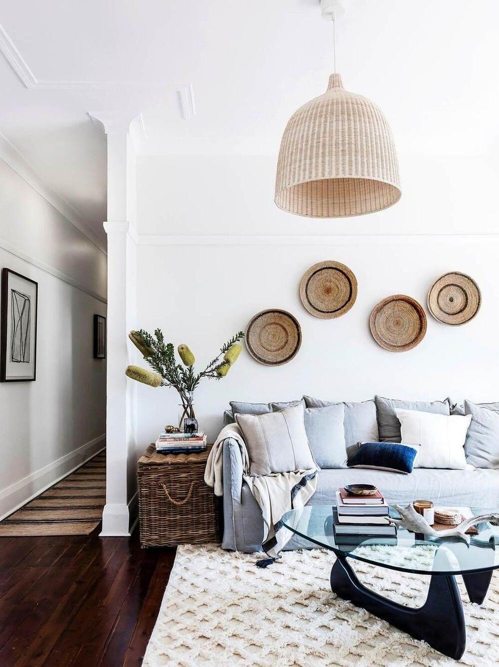 Rattan pendant above a sofa and wall baskets