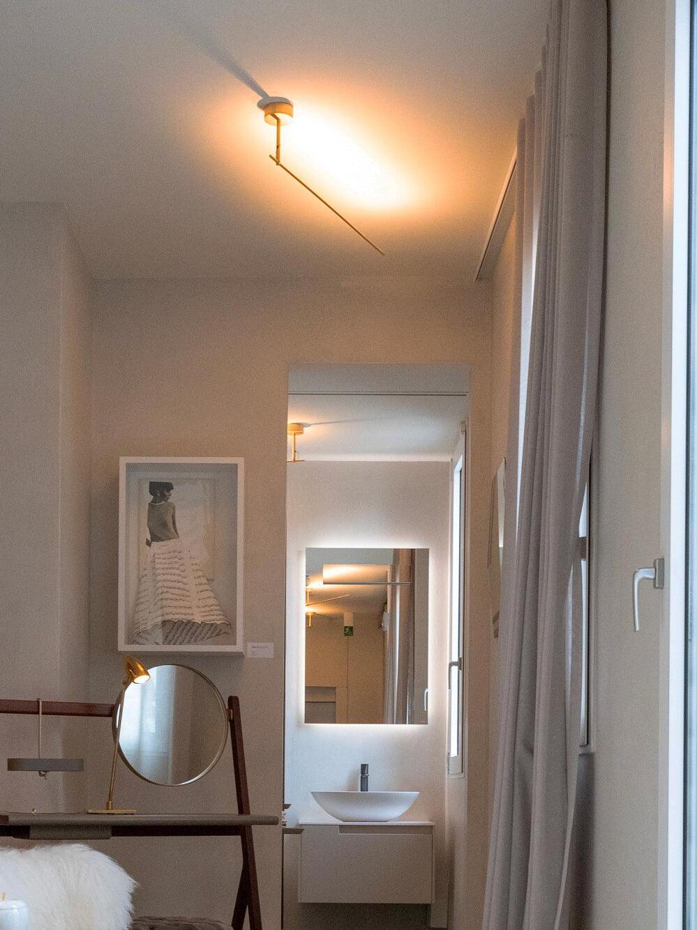 Angled slim wall light near a doorway
