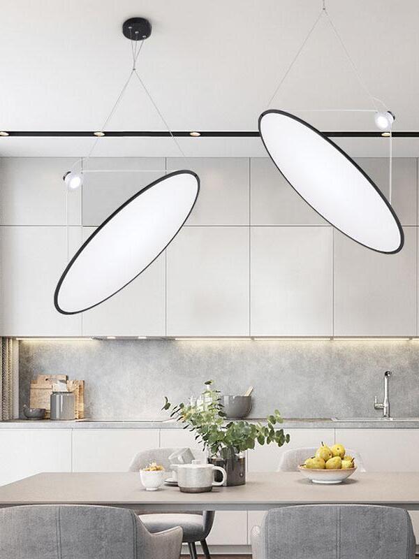 Angled disc pendants above a kitchen counter
