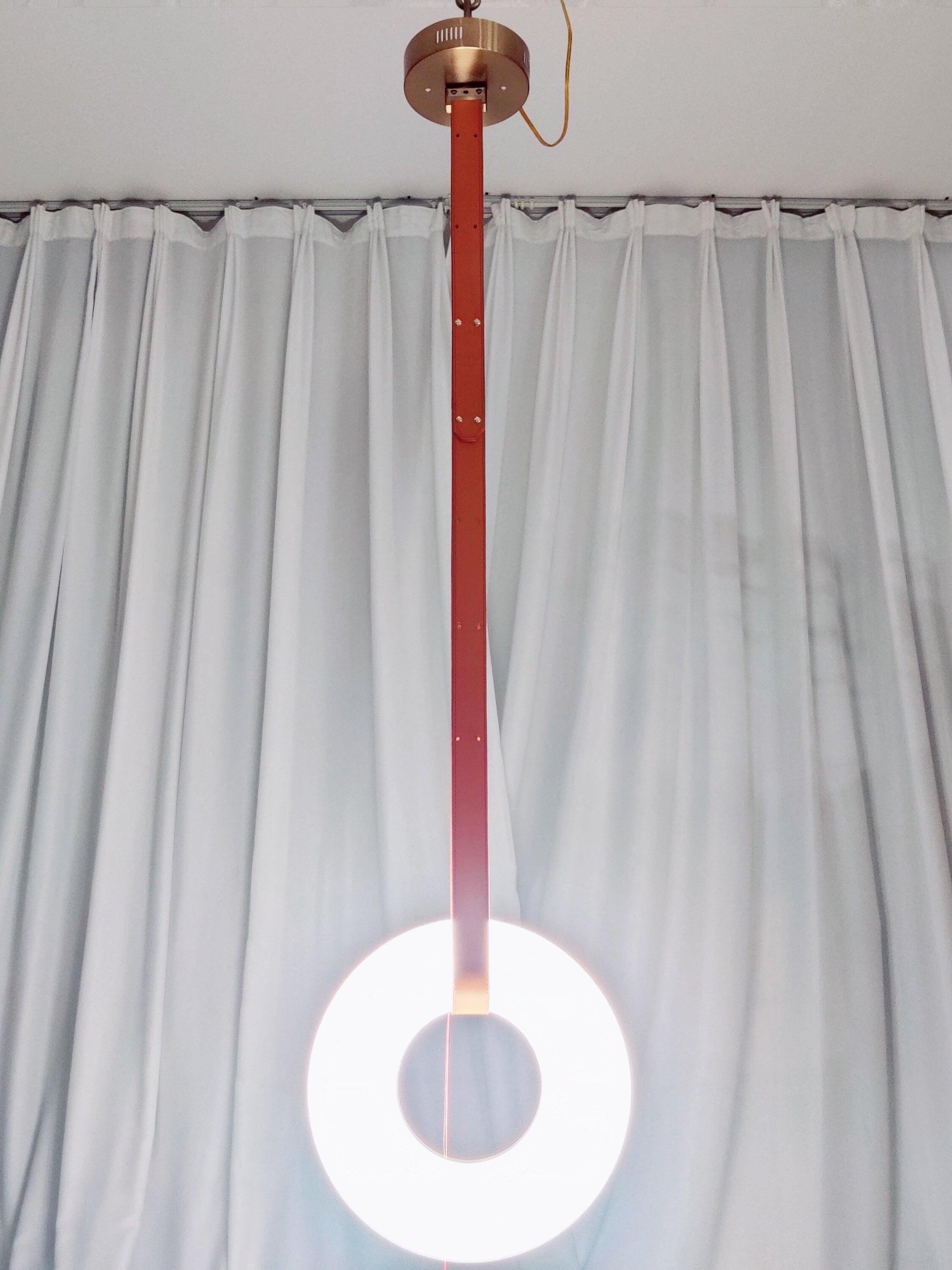 Upright ring pendant on a long strap