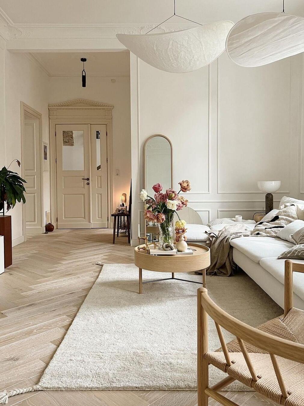 Curved shades above a light-toned living room